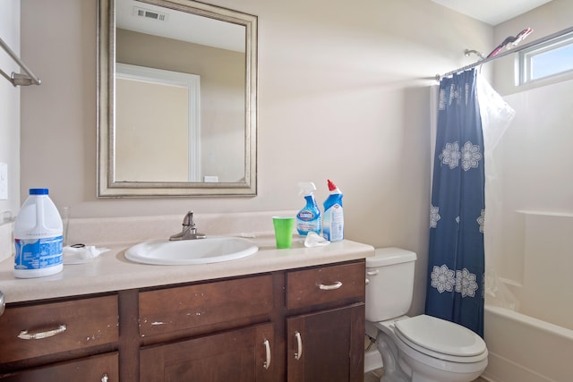 full bathroom with vanity, toilet, and shower / tub combo