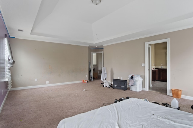 bedroom with carpet, ensuite bathroom, and ornamental molding