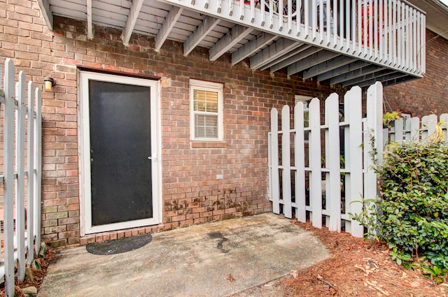 view of exterior entry featuring a patio