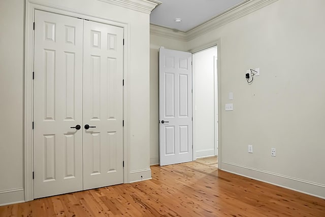 4252 Faber Place Dr Unit 203, North Charleston, SC 29405 - unfurnished bedroom featuring ornamental molding, light wood-type flooring, a closet, and baseboards