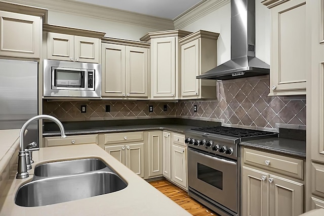 4252 Faber Place Dr Unit 203, North Charleston, SC 29405 - kitchen featuring wall chimney range hood, built in appliances, a sink, ornamental molding, and light wood-style floors