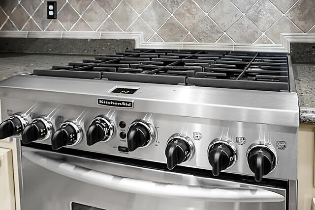 4252 Faber Place Dr Unit 203, North Charleston, SC 29405 - kitchen view of stainless steel gas stove and decorative backsplash
