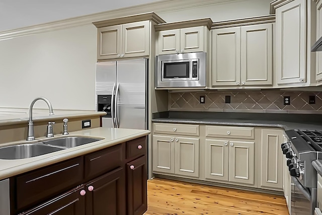4252 Faber Place Dr Unit 203, North Charleston, SC 29405 - kitchen with stainless steel appliances, a sink, crown molding, tasteful backsplash, and light wood-style floors