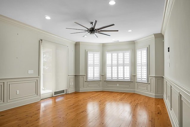 4252 Faber Place Dr Unit 203, North Charleston, SC 29405 - spare room featuring a decorative wall, plenty of natural light, light wood finished floors, a ceiling fan, and ornamental molding