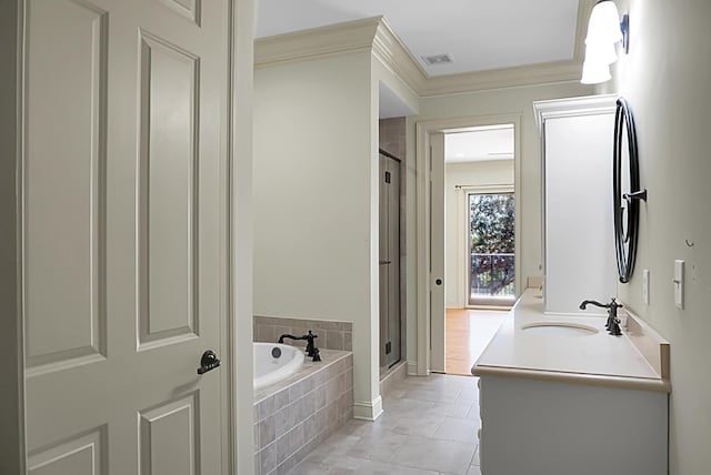 4252 Faber Place Dr Unit 203, North Charleston, SC 29405 - bathroom featuring a shower stall, a bath, vanity, ornamental molding, and tile patterned floors