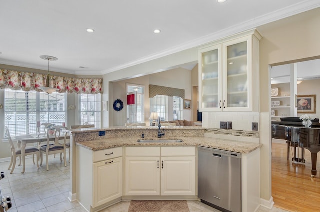 kitchen with dishwasher, a sink, ornamental molding, light stone counters, and glass insert cabinets