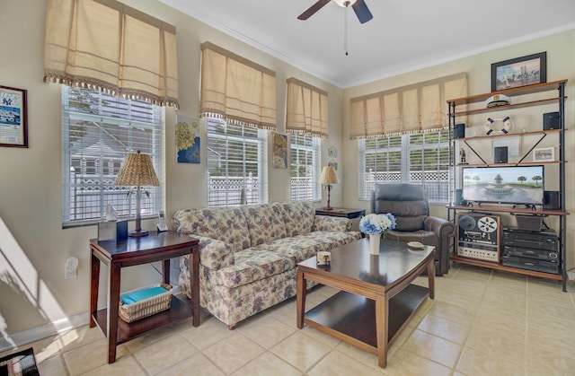 living area with crown molding, a ceiling fan, and light tile patterned floors