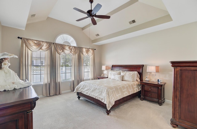 bedroom featuring light colored carpet, lofted ceiling, baseboards, and a ceiling fan