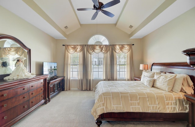 bedroom with light carpet, vaulted ceiling, and a ceiling fan