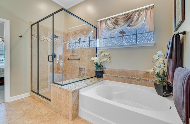 full bathroom featuring a stall shower, a garden tub, and tile patterned floors
