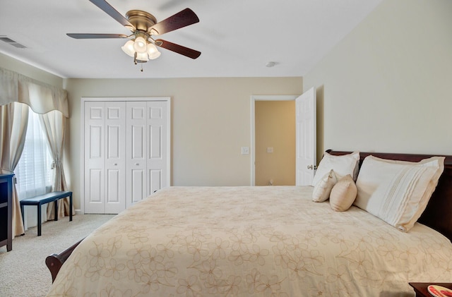 carpeted bedroom featuring a closet and a ceiling fan