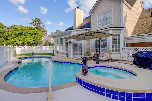 view of pool featuring french doors, a patio area, a fenced backyard, an in-ground hot tub, and grilling area