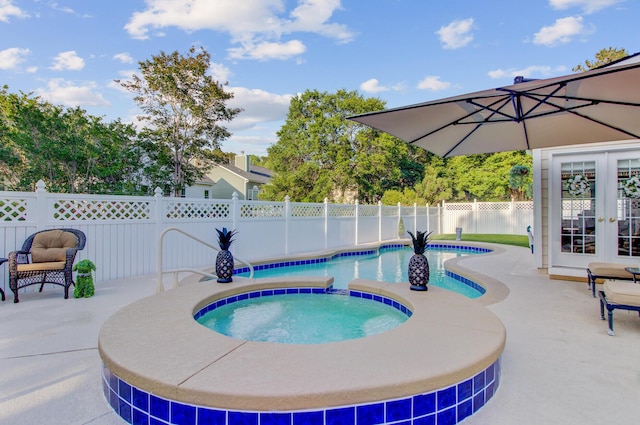 view of swimming pool featuring an in-ground hot tub, french doors, a fenced backyard, and a patio