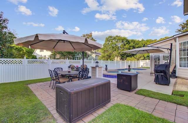 view of patio with a grill, an in-ground hot tub, and outdoor dining space