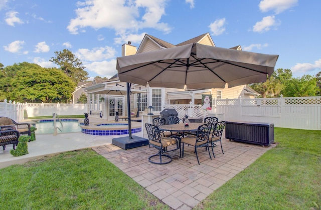 view of patio / terrace featuring an in-ground hot tub and french doors