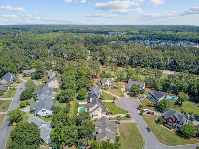 aerial overview of property's location with a forest and nearby suburban area