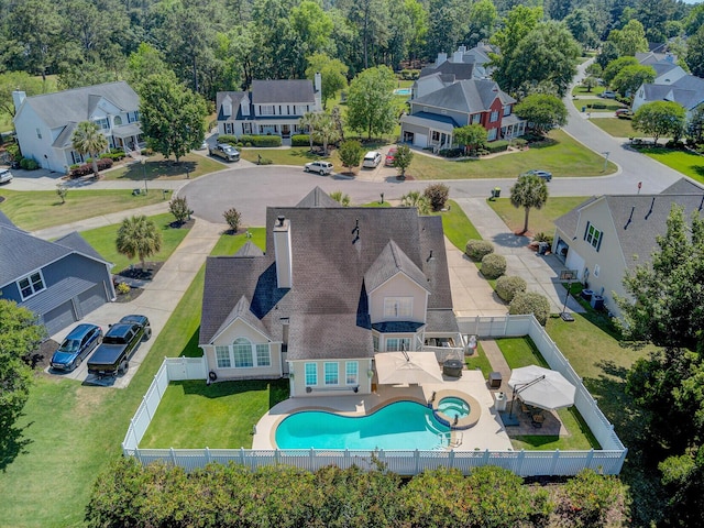 aerial perspective of suburban area featuring a pool area