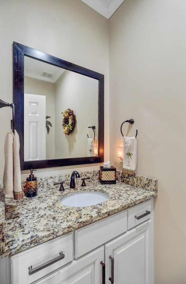 bathroom featuring vanity and crown molding