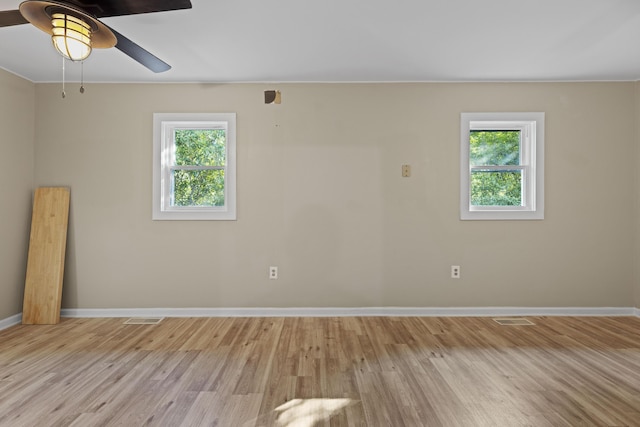 121 Harrison St, Varnville, SC 29944 - empty room with light wood-style flooring, ceiling fan, and baseboards