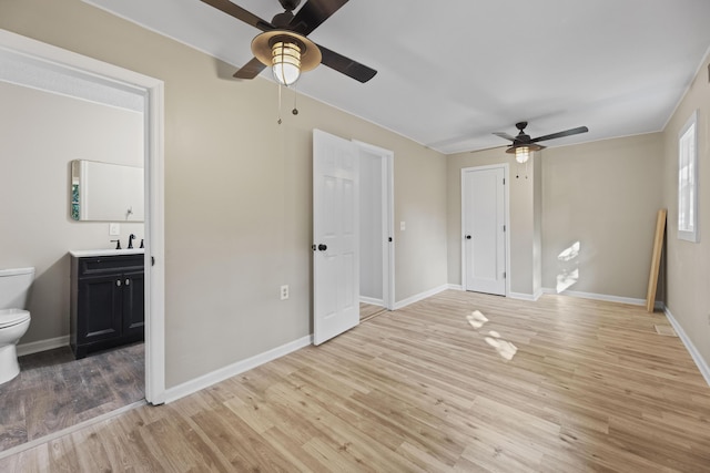 121 Harrison St, Varnville, SC 29944 - unfurnished bedroom with a sink, light wood-type flooring, baseboards, and ensuite bathroom