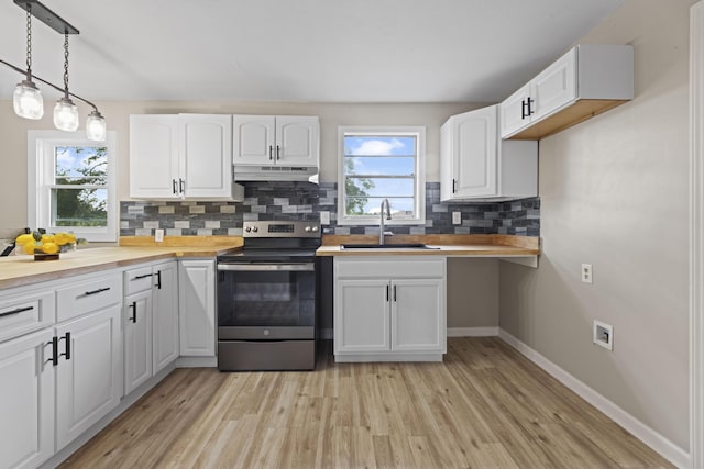 121 Harrison St, Varnville, SC 29944 - kitchen featuring electric range, a sink, backsplash, light wood-style flooring, and wooden counters