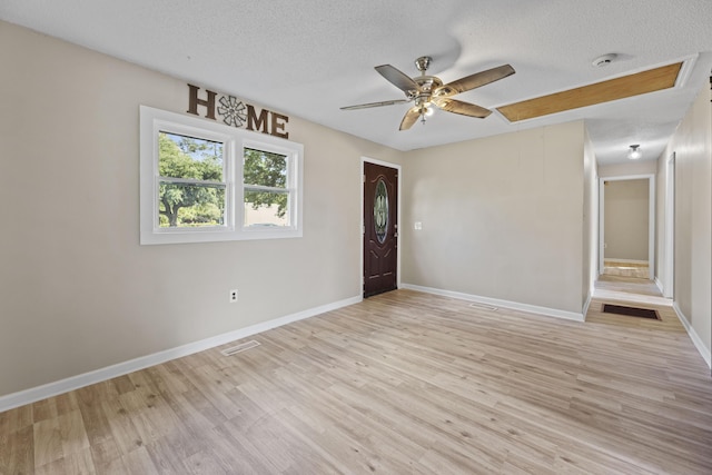 121 Harrison St, Varnville, SC 29944 - spare room featuring a textured ceiling, light wood finished floors, ceiling fan, baseboards, and a smoke detector