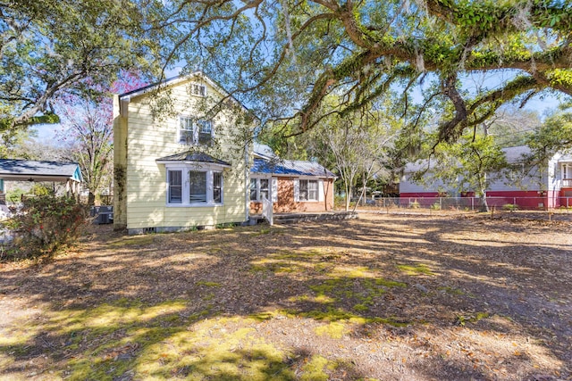 view of front of property featuring cooling unit, crawl space, and fence