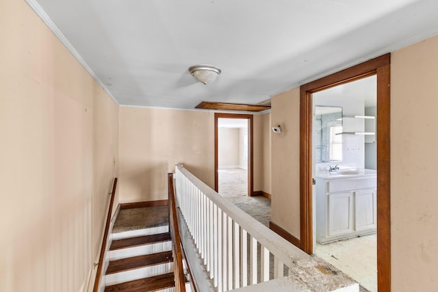 stairway with crown molding and baseboards