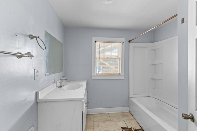 bathroom with bathtub / shower combination, vanity, baseboards, and tile patterned floors