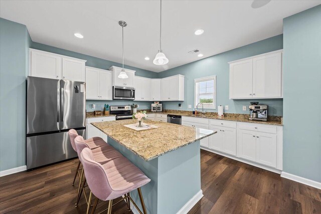 3055 Matthews Dr, Sumter, SC 29154 - kitchen featuring appliances with stainless steel finishes, a sink, light stone counters, dark wood-type flooring, and recessed lighting