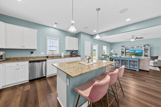 3055 Matthews Dr, Sumter, SC 29154 - kitchen featuring stainless steel dishwasher, open floor plan, light stone counters, dark wood-style flooring, and a kitchen island