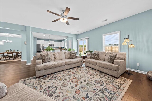 3055 Matthews Dr, Sumter, SC 29154 - living area featuring a ceiling fan, dark wood-type flooring, baseboards, and a chandelier