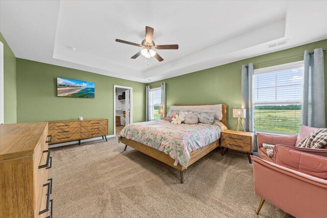 3055 Matthews Dr, Sumter, SC 29154 - carpeted bedroom featuring a tray ceiling and ceiling fan