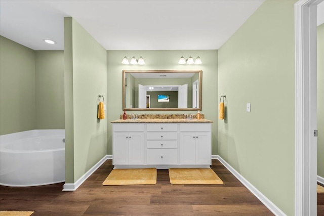 3055 Matthews Dr, Sumter, SC 29154 - full bath with wood finished floors, baseboards, a bathtub, and recessed lighting