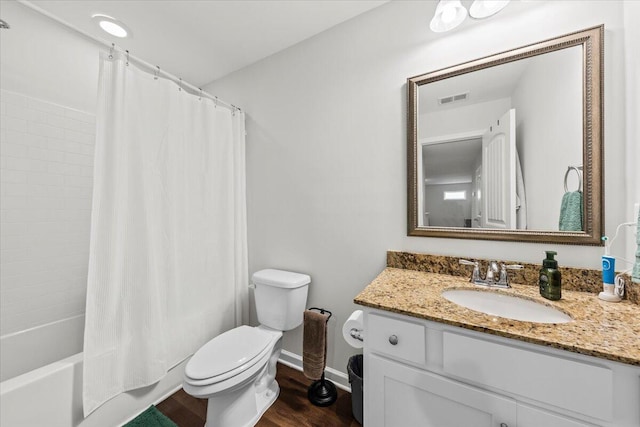 3055 Matthews Dr, Sumter, SC 29154 - bathroom with toilet, wood finished floors, baseboards, vanity, and shower / tub combo with curtain