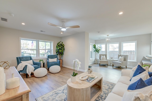 living room featuring ceiling fan and light wood-type flooring