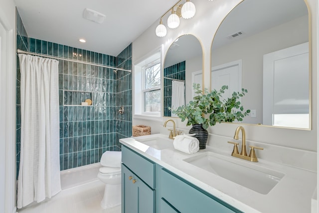 bathroom with walk in shower, tile patterned floors, vanity, and toilet