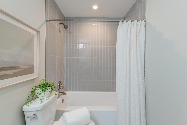 bathroom with shower / bath combination with curtain and toilet