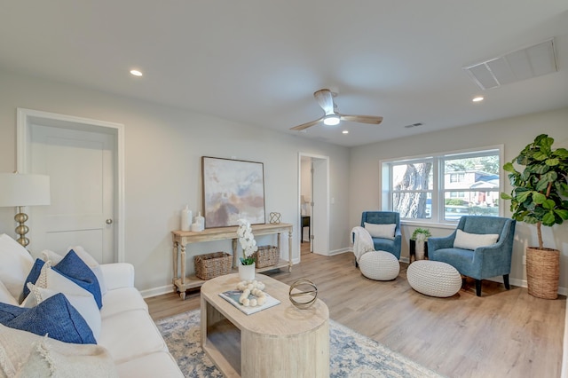 living room featuring ceiling fan and light hardwood / wood-style flooring