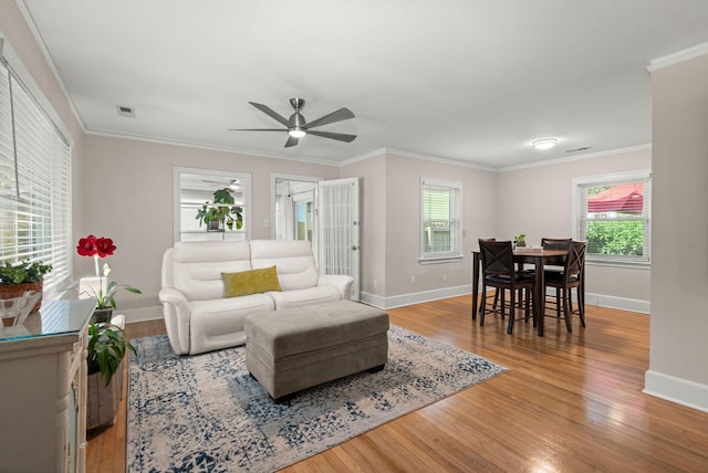 672 W Oak Forest Dr, Charleston, SC 29407 - living area featuring wood finished floors, baseboards, ceiling fan, and crown molding