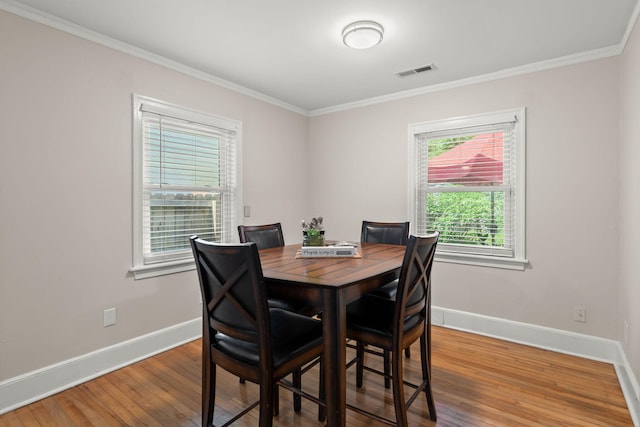 672 W Oak Forest Dr, Charleston, SC 29407 - dining area featuring baseboards, ornamental molding, and wood finished floors