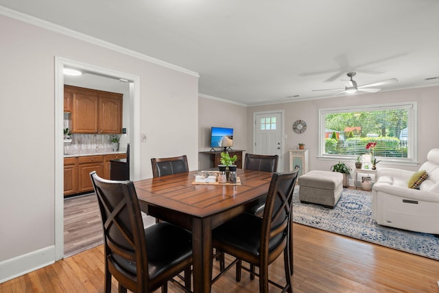 672 W Oak Forest Dr, Charleston, SC 29407 - dining area with light wood finished floors, crown molding, a ceiling fan, and baseboards