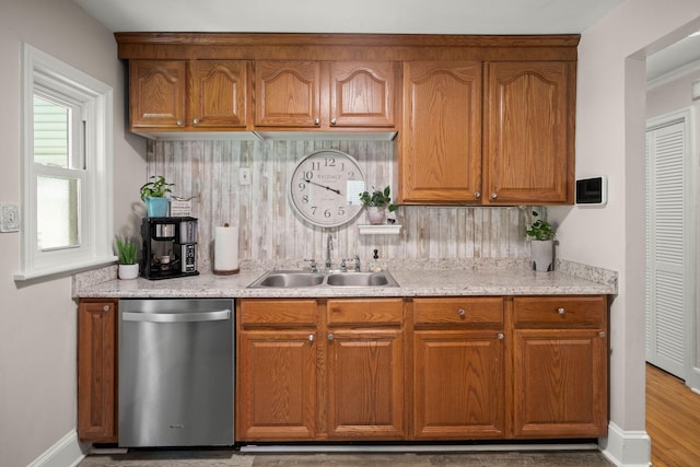 672 W Oak Forest Dr, Charleston, SC 29407 - kitchen with stainless steel dishwasher, a sink, tasteful backsplash, and brown cabinetry