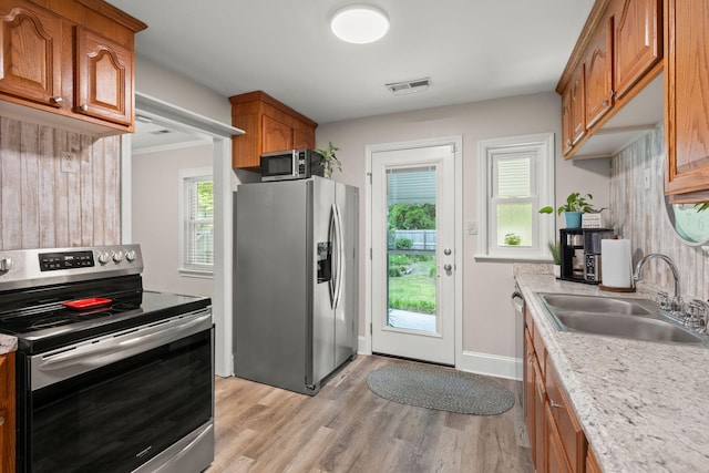 672 W Oak Forest Dr, Charleston, SC 29407 - kitchen featuring stainless steel appliances, a sink, and brown cabinetry