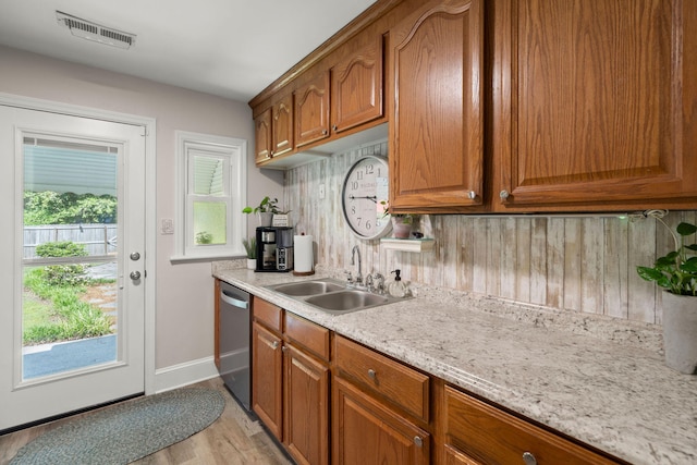672 W Oak Forest Dr, Charleston, SC 29407 - kitchen featuring a sink, dishwasher, light wood-type flooring, and brown cabinets
