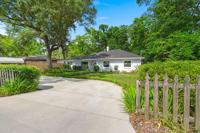 672 W Oak Forest Dr, Charleston, SC 29407 - view of front facade with concrete driveway and a chimney