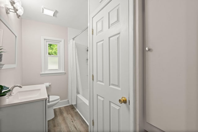 672 W Oak Forest Dr, Charleston, SC 29407 - full bath with toilet, vanity, wood finished floors, baseboards, and shower / bathtub combination with curtain