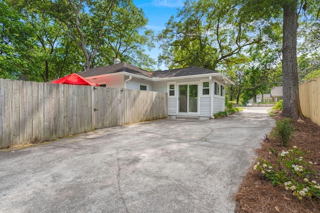 672 W Oak Forest Dr, Charleston, SC 29407 - rear view of house featuring fence and concrete driveway