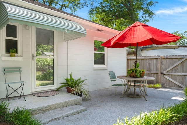672 W Oak Forest Dr, Charleston, SC 29407 - view of patio / terrace with fence, a gate, and outdoor dining area