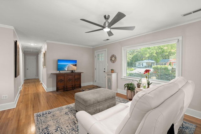 672 W Oak Forest Dr, Charleston, SC 29407 - living room with light wood-style flooring, ornamental molding, ceiling fan, baseboards, and attic access